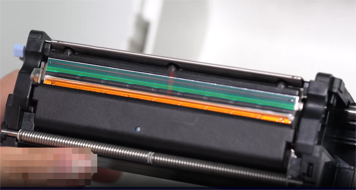 А close-up of a person carefully cleaning an electronic component with a swab.