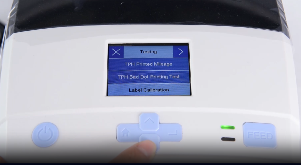 А close-up of a machine's digital interface showing a testing menu.